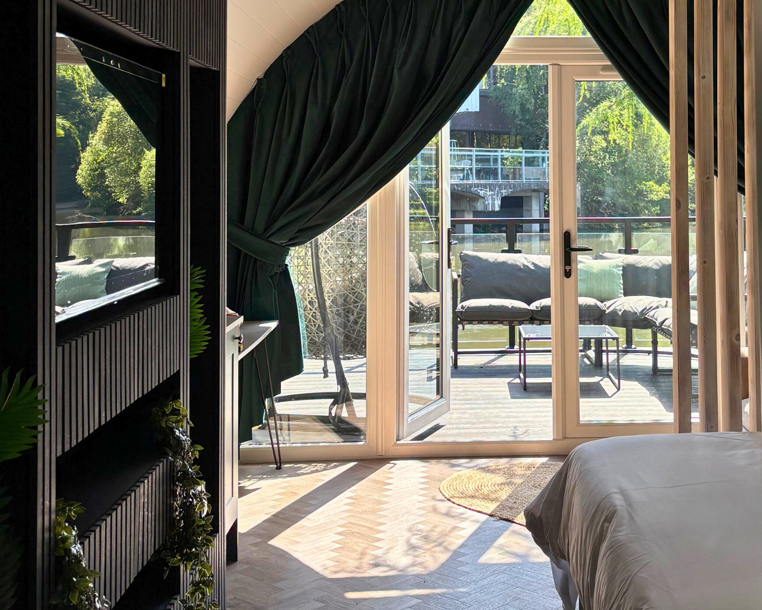 Stylish pod interior with curtains opening onto a private deck